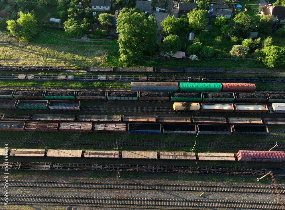 Railway yard with freight rail wagons. Cargo trains with goods on