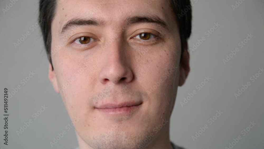 face of a young man smiling close up. happy brown-eyed man face of a young man smiling close up. happy brown-eyed man