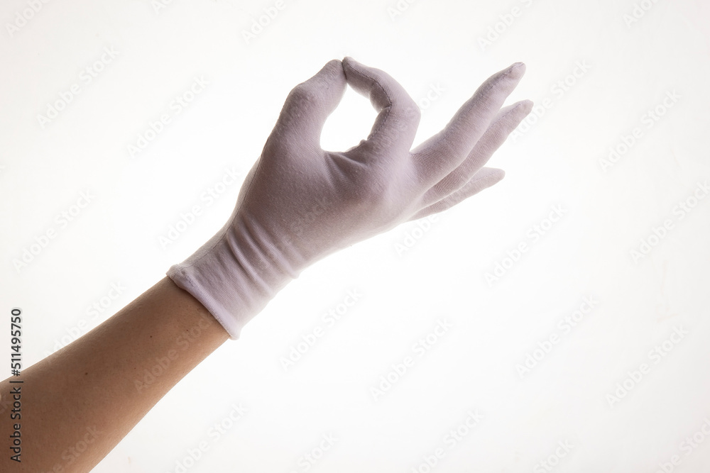 Hands gesticulating in white textile gloves on a white background Hands gesticulating in white textile gloves on a white background