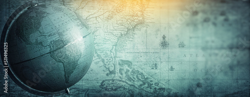 Ancient globe on the old map background. Selective focus. Retro style. Science, education, travel, vintage background. History and geography team. Blue tinted.