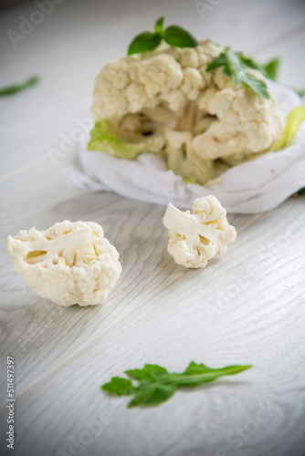 inflorescences of small cauliflower on a light wooden table