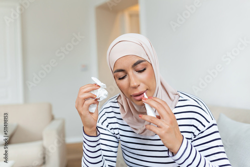 Sick Arabic Woman with hijab is Using Nasal Spray Due to the Problems with Nose and Breathing