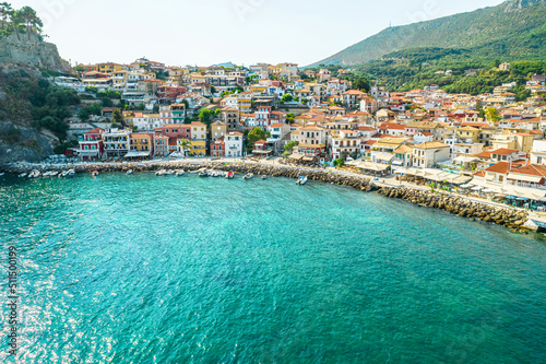 Fototapeta Naklejka Na Ścianę i Meble -  Beautiful colorful houses of seaside town of Parga with boats, cruise ship. Sand beach with umbrellas, tourist people, blue, turquoise sea water. Summer vacations and travel concept. Greece. 