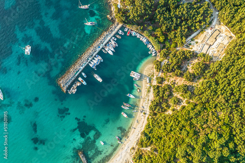 Port, pier, dock with boats, cruise ship in blue, turquoise sea water. Summer vacations and travel concept. Marina. Aerial, drone view
