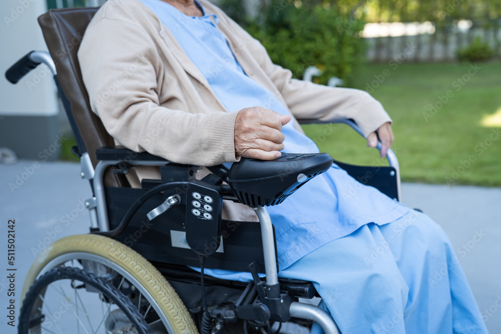 Obraz premium Asian senior or elderly old lady woman patient on electric wheelchair with remote control at nursing hospital ward, healthy strong medical concept