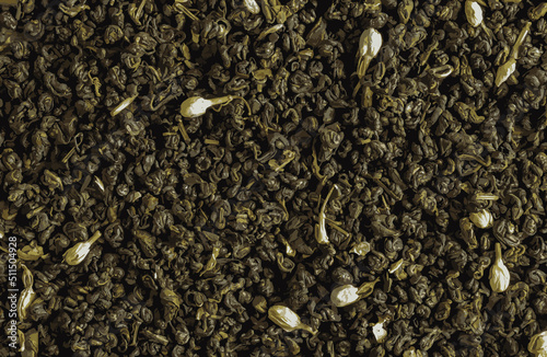 Realistic vector illustration of green dry tea with jasmine flowers. Background and texture of dry tea.
