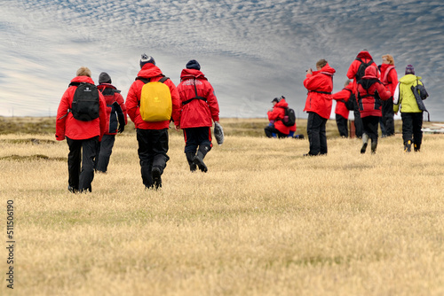 Tourists hiking the northern part of Bleaker Island (part of the Falkland Islands) in search of Penguins, Seals and Seabirds.