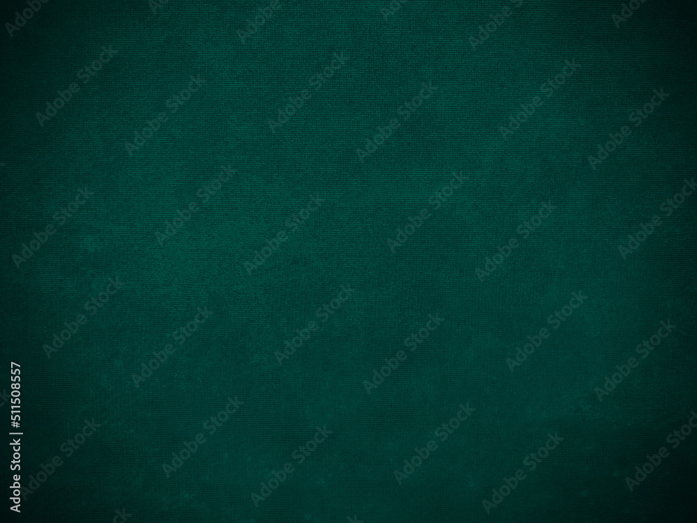 Dark green old velvet fabric texture used as background. Empty green fabric background of soft and smooth textile material. There is space for text...