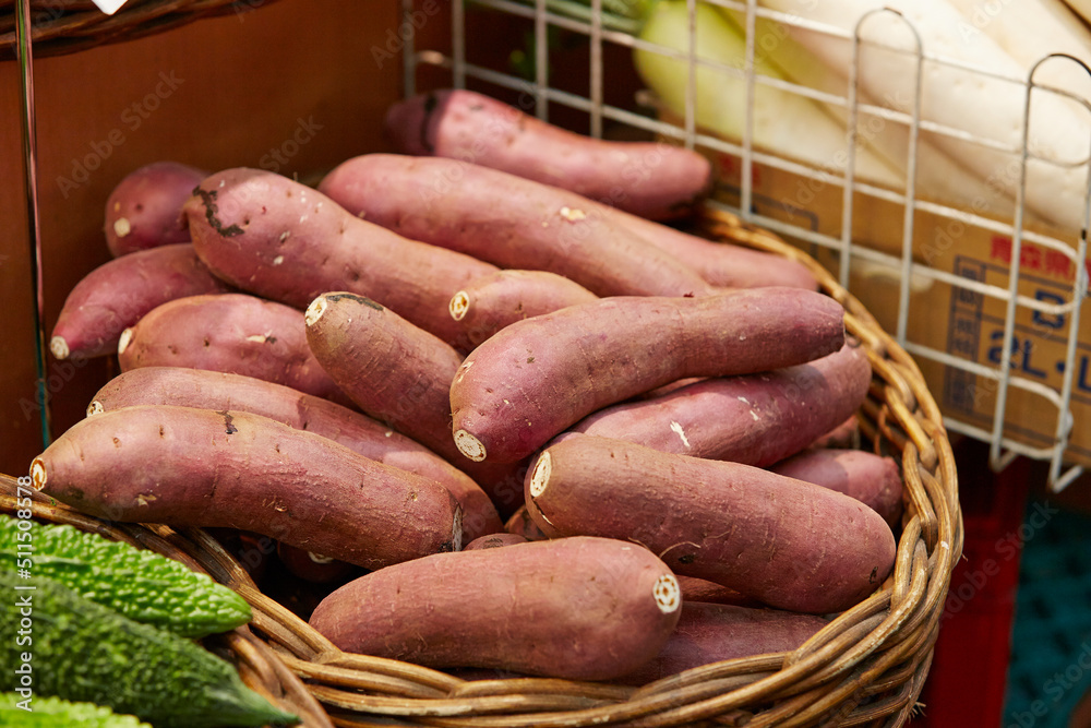 Fresh sweet potatoes on display at the market Fresh sweet potatoes on display at the market