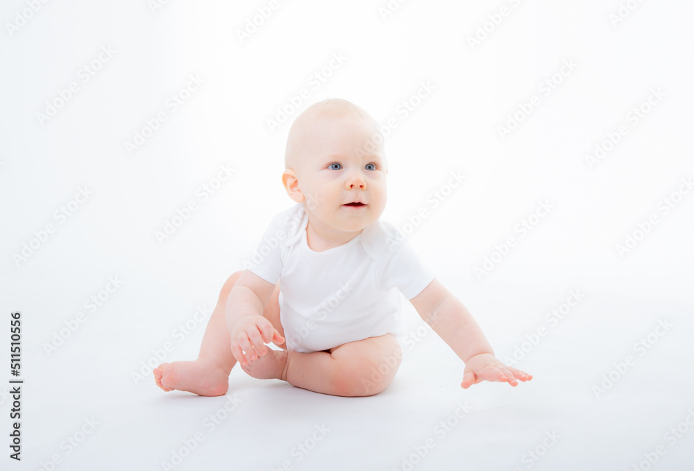baby boy in a white bodysuit crawling on a white background baby boy in a white bodysuit crawling on a white background