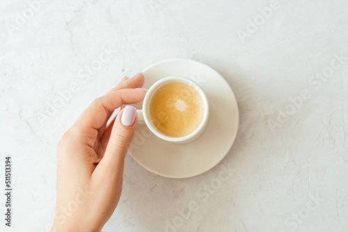 A cup of espresso on a gray background.