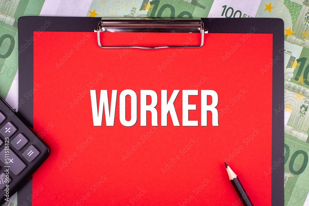 WORKER - word on the background of money, a notepad and a pencil with a calculator. Business concept (copy space). WORKER - word on the background of money, a notepad and a pencil with a calculator. Business concept (copy space).