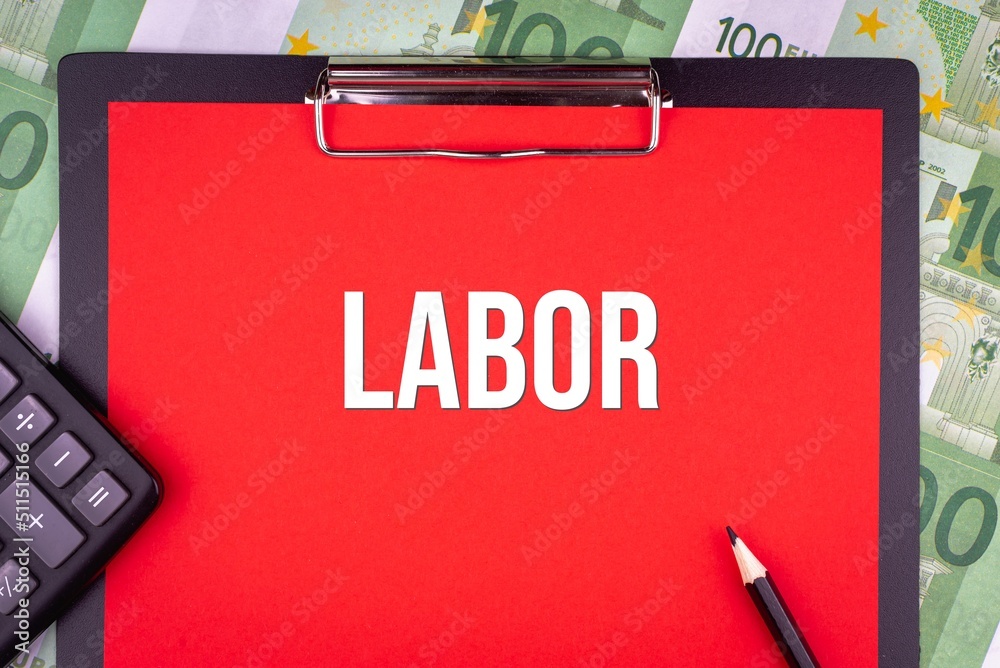 LABOR - word on the background of money, a notepad and a pencil with a calculator. Business concept (copy space). LABOR - word on the background of money, a notepad and a pencil with a calculator. Business concept (copy space).
