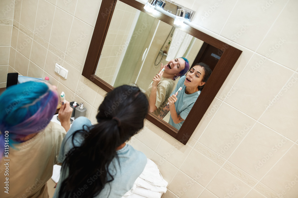 Young girls sing in toothbrushes like microphones Young girls sing in toothbrushes like microphones