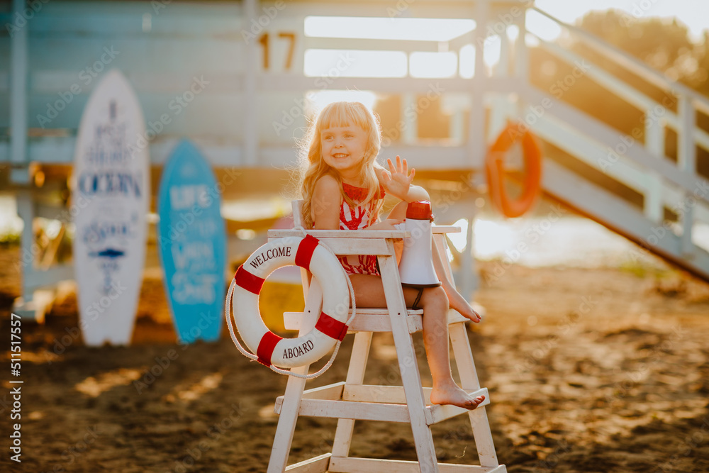 Girl in red bikini posing with megaphone sitting on summer chair at the ...