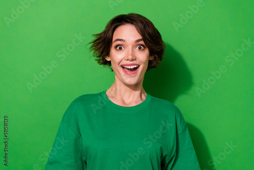 Photo of sweet impressed woman wear casual t-shirt smiling open mouth isolated green color background