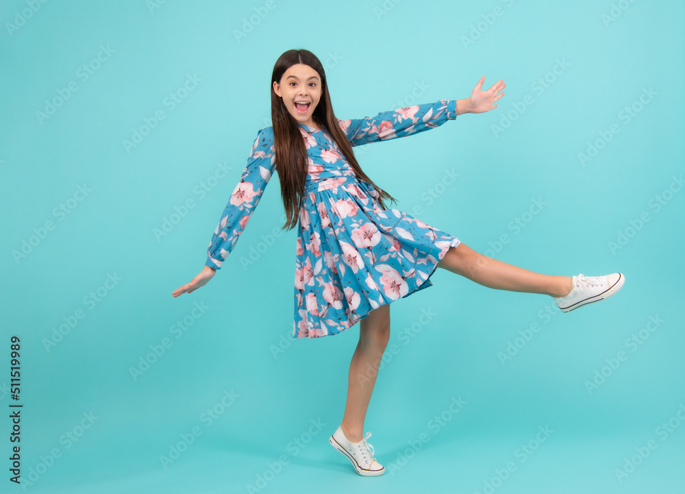 Happiness, freedom, motion and child. Young teenager girl jumping over blue background, funny jump. Excited teenager, amazed and cheerful emotions. Happiness, freedom, motion and child. Young teenager girl jumping over blue background, funny jump. Excited teenager, amazed and cheerful emotions.