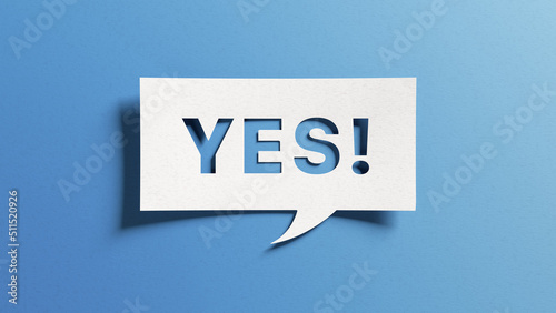 Yes sign showing positive answer, joy, agreement, celebration, affirmative decision or determination. Word yes on cutout paper speech buble on blue background. photo