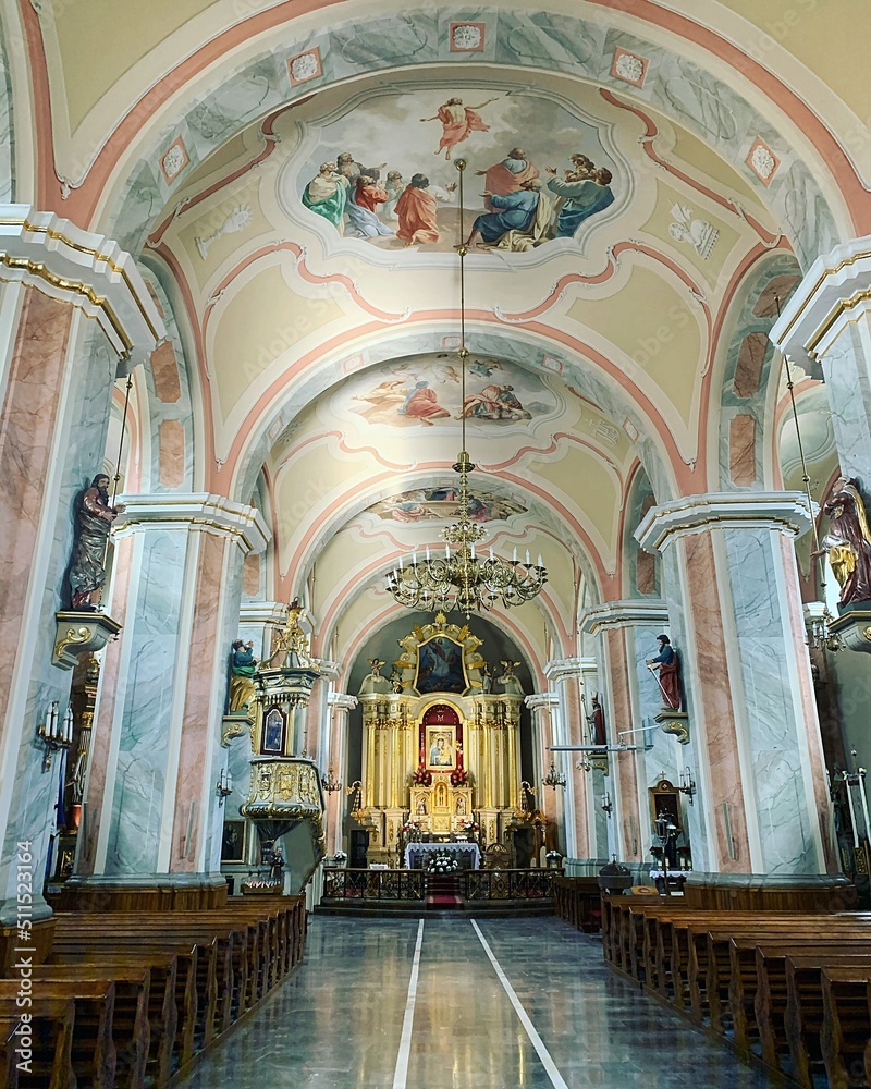 church interior, church pews, large altar in church, paintings on ceiling, golden altar, chandelier hanging from a long pole, decorations, ornaments, marble floor