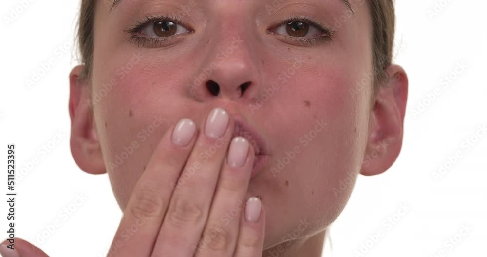 Close up of a woman's face blowing air kisses with her hands. Isolated on white background. Close up of a woman's face blowing air kisses with her hands. Isolated on white background.