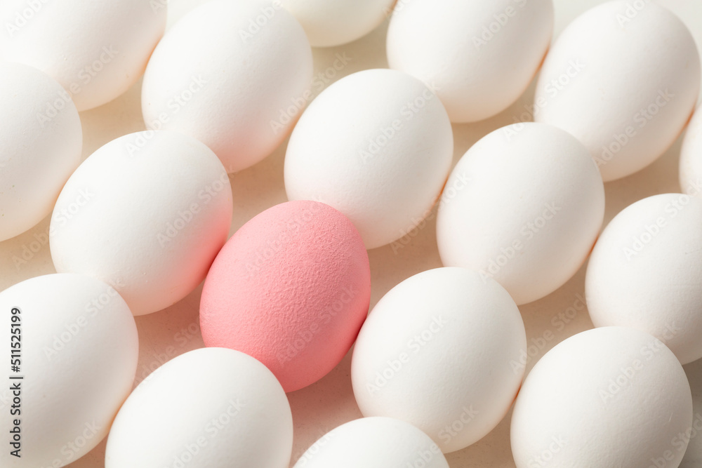 Eggs, one pink and the other white, coceptual photo Eggs, one pink and the other white, coceptual photo