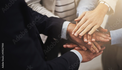 Where there is unity there is victory. Cropped shot of a group of businesspeople putting their hands together in unity.