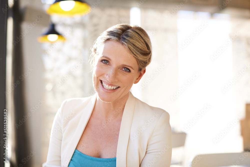 Shes radiating confidence. Portrait of an attractive mature woman sitting indoors. Shes radiating confidence. Portrait of an attractive mature woman sitting indoors.