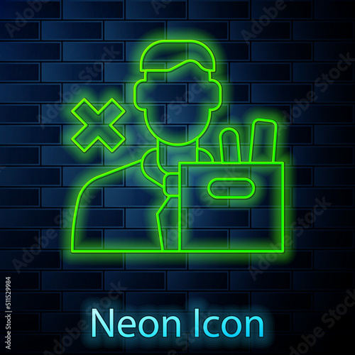 Fotografie, Obraz Glowing neon line Dismissed sad young man carrying box with his personal belonging leaving his job icon isolated on brick wall background