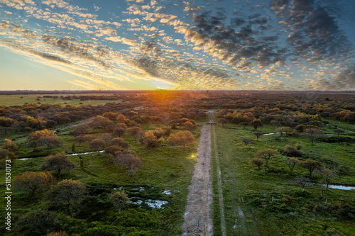 Sunset in the countryside in the province of buenos aires  argentina. aerial image of an empty dirt road. 