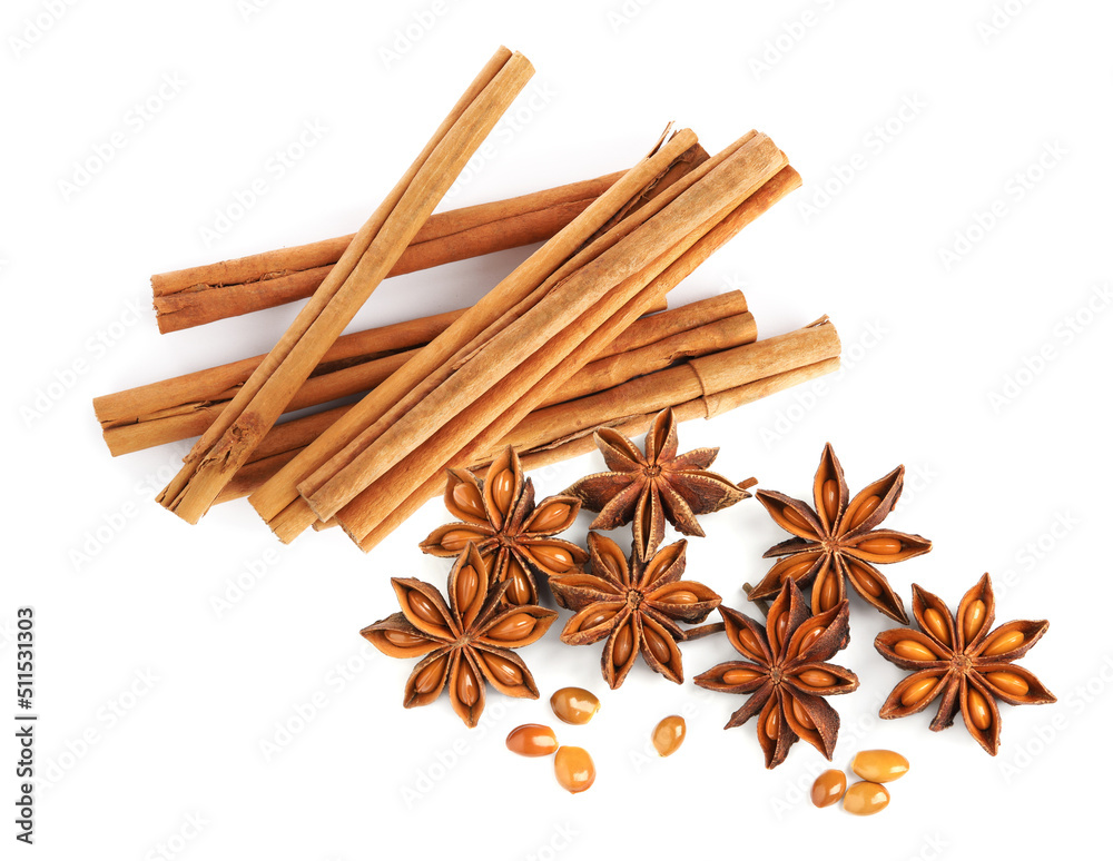 Aromatic cinnamon sticks and anise stars with seeds on white background, top view Aromatic cinnamon sticks and anise stars with seeds on white background, top view