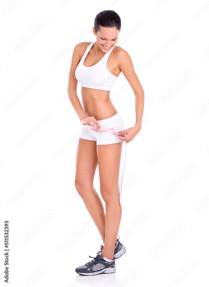 Looking good and now I know it. Studio shot of a fit young woman taking her measurements isolated on white. Looking good and now I know it. Studio shot of a fit young woman taking her measurements isolated on white.