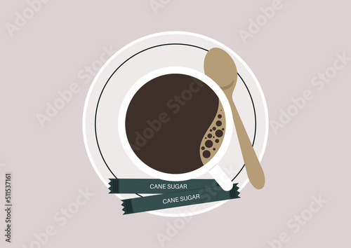 A top view of a cup of black coffee on a saucer with cane sugar packets