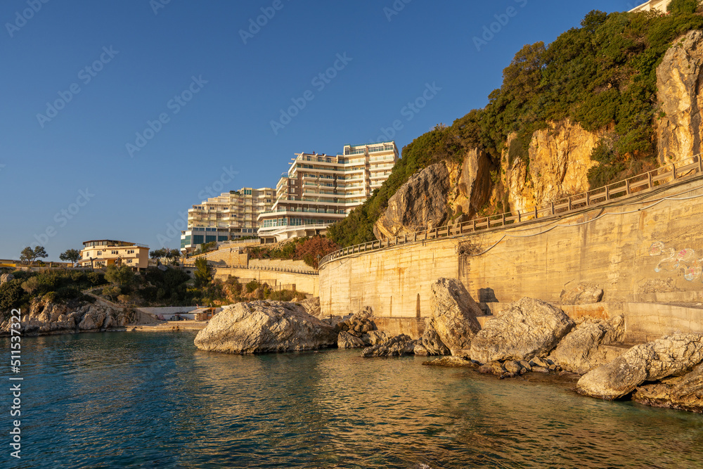 Sunset over a hotel at Vlore in Albania. Hills and mountains. Adriatic Sea.