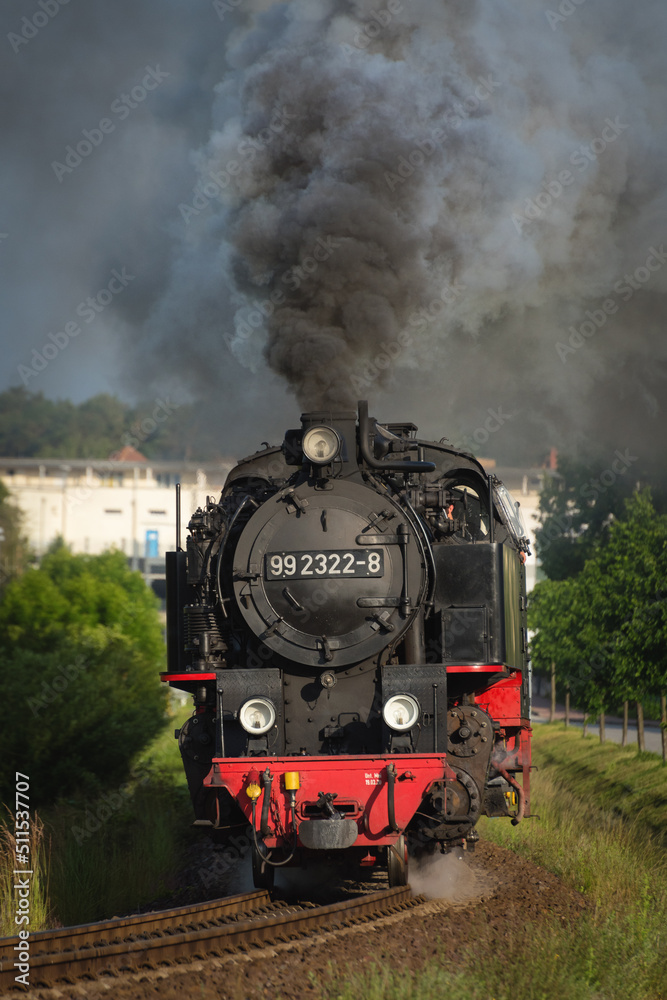 Obraz premium Vintage steam locomotive full steam ahead