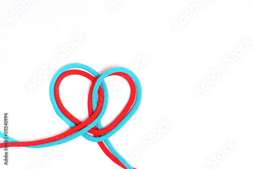 Heart symbol made of two braided cords on gray