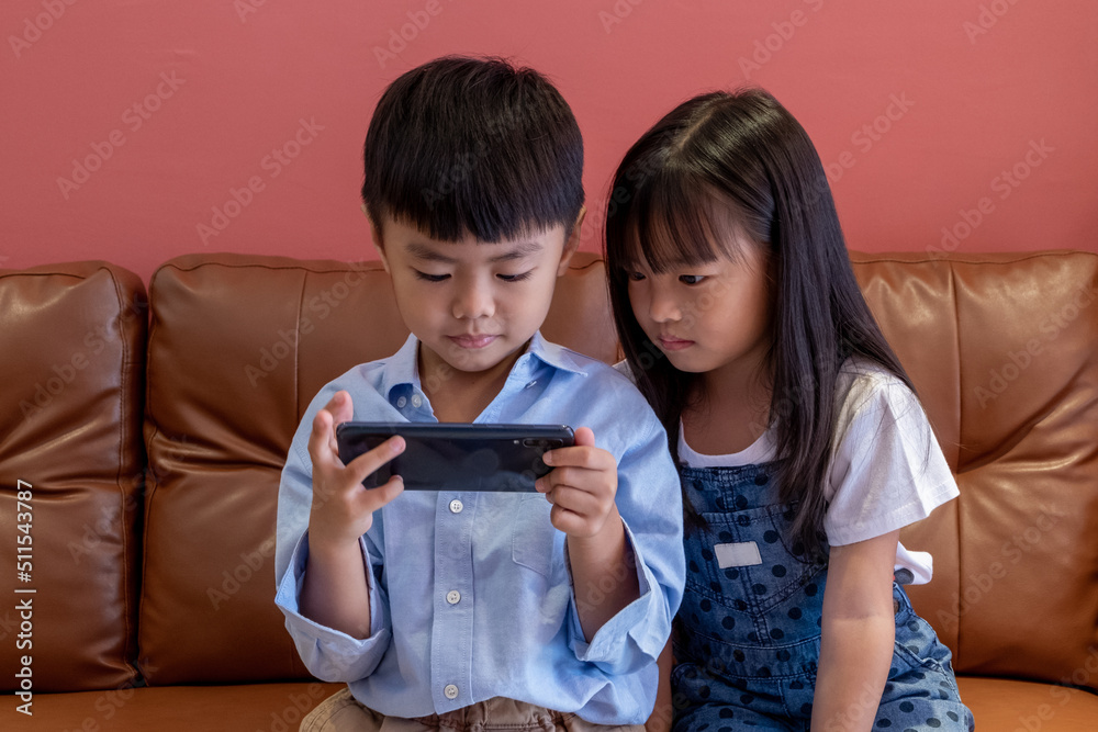 Girl and boy are playing on the phone. Girl and boy are playing on the phone.