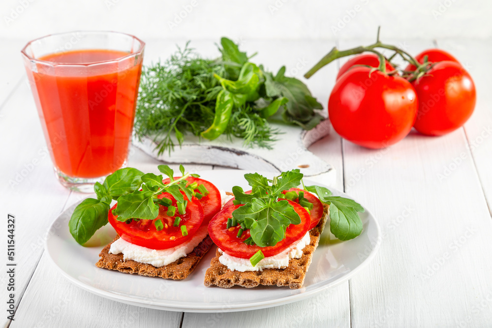 Crispbread with curd cheese, tomatoes, green onions, arugula and basilica. Delicious and healthy breakfast Crispbread with curd cheese, tomatoes, green onions, arugula and basilica. Delicious and healthy breakfast