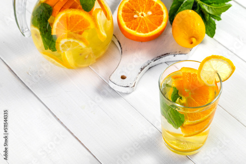 Citrus drink with lemon, orange and mint. Healthy and healthy drink in a transparent glass with copy space