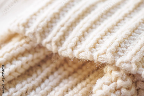 closeup beige knitted woolen fabric texture background