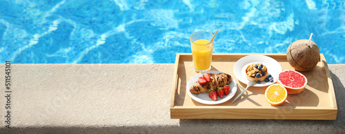 Tray with delicious breakfast near swimming pool, space for text. Banner design