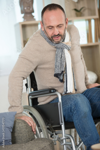 Obraz na plátne disable man trying to sit on a sofa