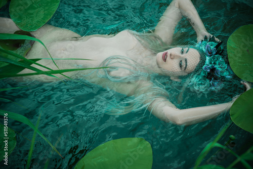 Old European magic, Mystical Pagan scene, woman in lake, rite. Magic divination in water, undina  photo