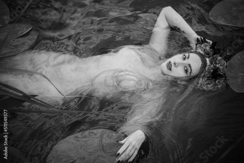 Old European magic, Mystical Pagan scene, woman in lake, rite. Magic divination in water, undina  photo