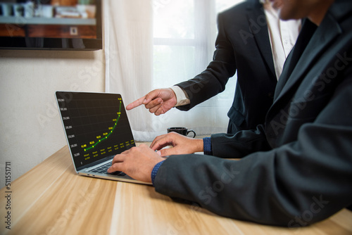 Manager's hand pointing out the project's sales and revenue graph analysis., business concept