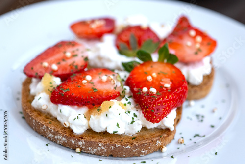 Healthy toast with strawberry, cottage cheese and honey. Tasty breakfast. Summer appetizer
