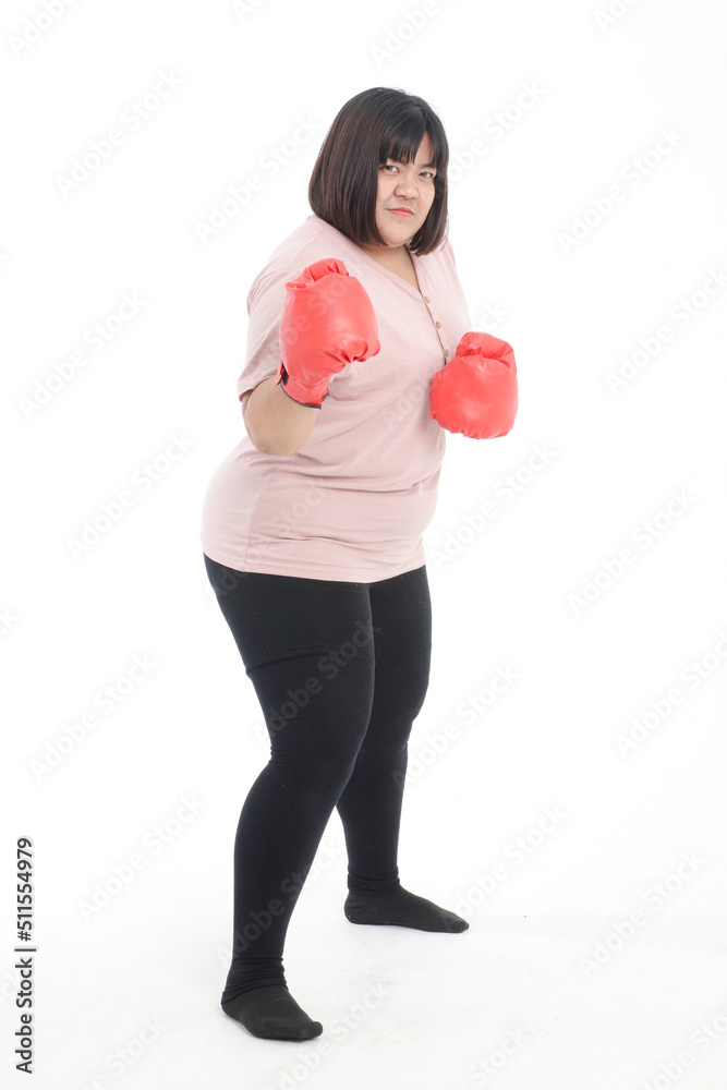 Fat Asian woman wearing red boxing gloves exercising on white background. Concept of exercise, weight loss, health care. Fat Asian woman wearing red boxing gloves exercising on white background. Concept of exercise, weight loss, health care.