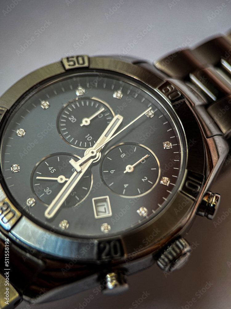 Luxury stainless steel watch with chronograph, dark blue dial and metal bracelet close-up. Macrophotography of watch details Luxury stainless steel watch with chronograph, dark blue dial and metal bracelet close-up. Macrophotography of watch details