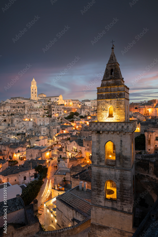 Stunning view of the illuminated village of Matera during a beautiful sunset. Matera is a city on a rocky outcrop in the region of Basilicata, in southern Italy.