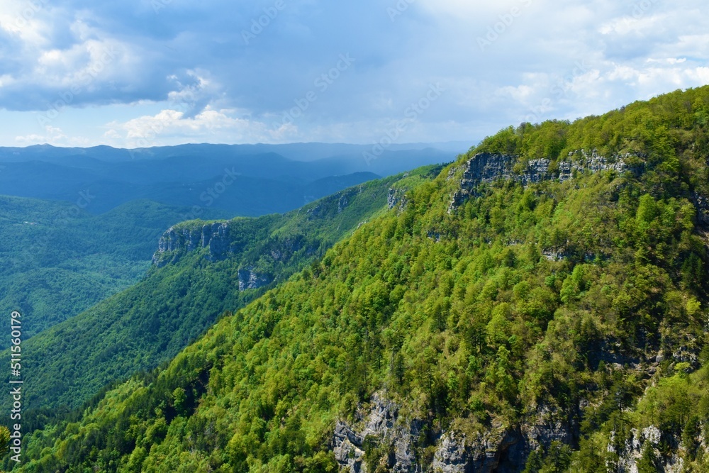 View of forest covere mountain slopes above Kolpa valley in Slovenia and Risnjak mountains in Croatia behind
