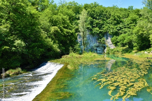 Waterfall at the spring of river Krupa in Bela Krajina in Dolenjska, Slovenia in summer